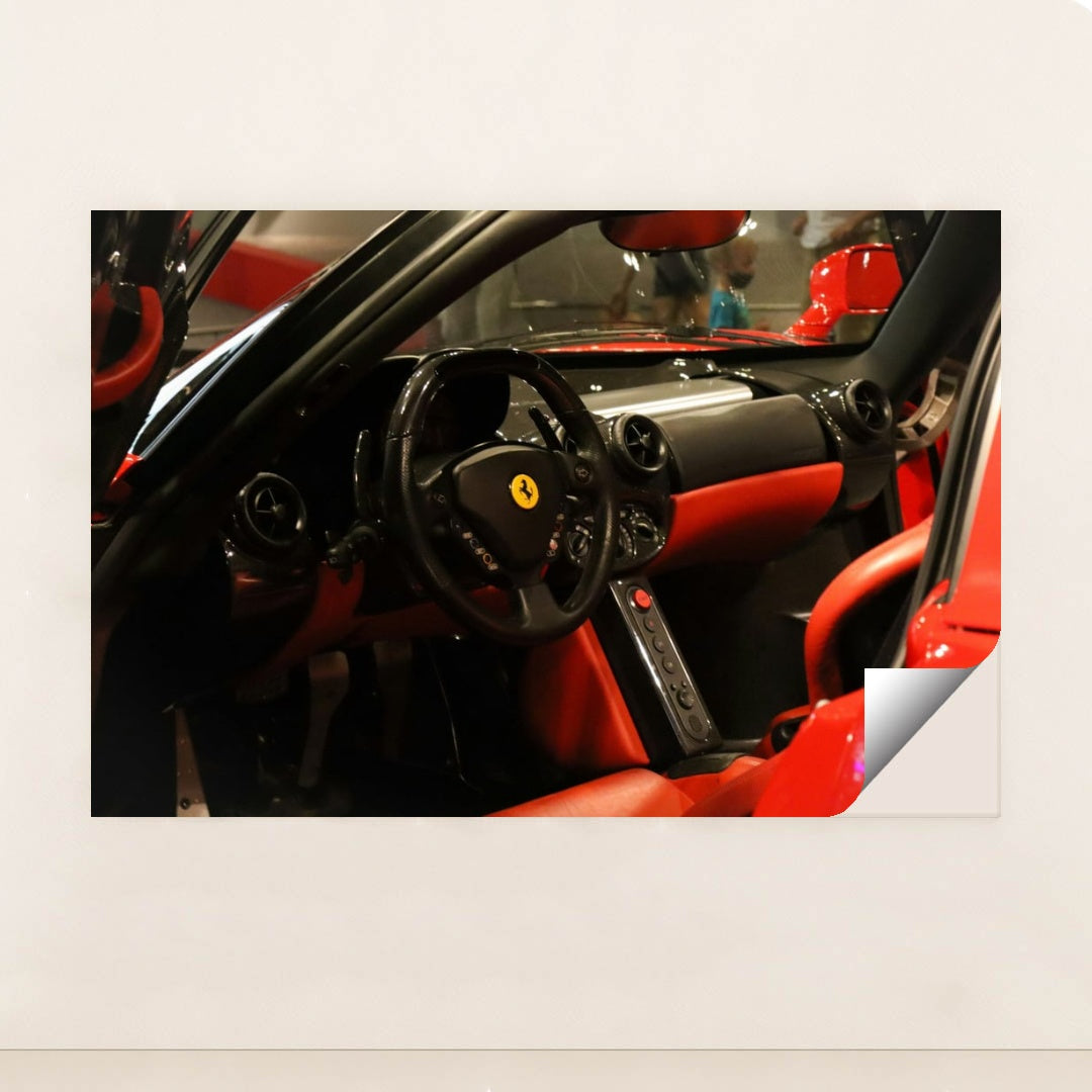 This photo shows the black and red leather interior of a Ferrari, featuring a round steering wheel and minimalist dash, minimalist unframed style.