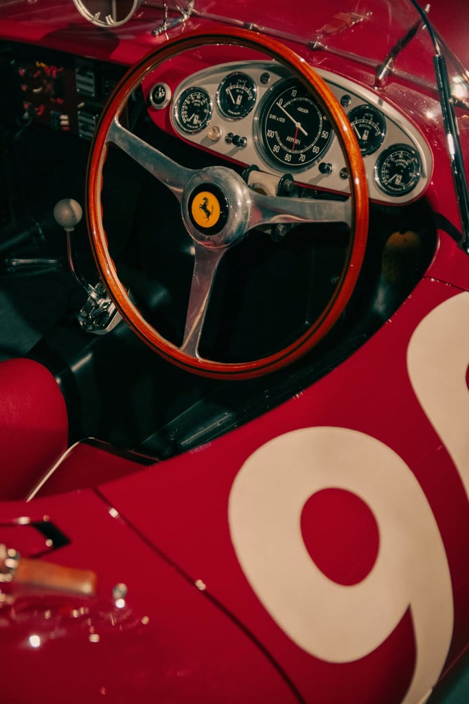 Close-up of Classic Ferrari Racing Dash featuring polished wood steering wheel and vintage gauges, ideal car wall art.