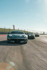 Ferrari Supercars in Action, featuring matte silver F12tdf and two other Ferraris racing on a sunlit track.