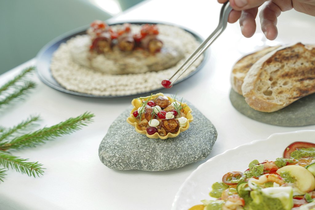 Nadin Sh - A chef carefully garnishes a gourmet dish with culinary precision and artistry.