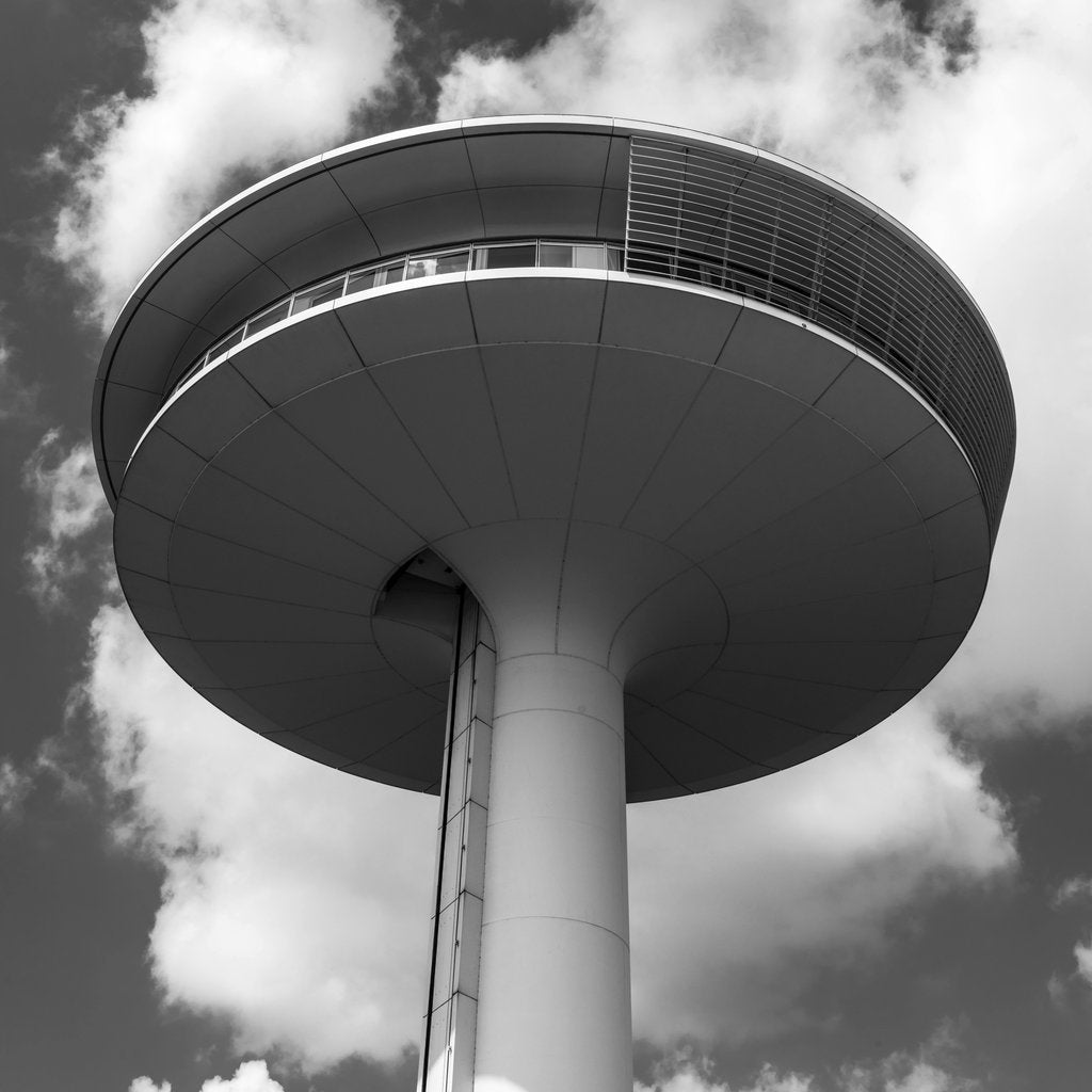 Wolfgang Weiser - Black and white image of a modern architectural tower against a cloudy sky in Hamburg.
