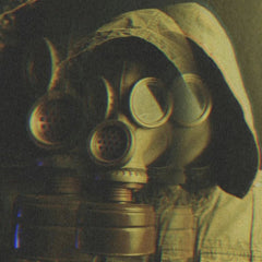 Furkan AYDİLEK - Vintage film photo of a person in a gas mask, using multi-exposure for an eerie effect.