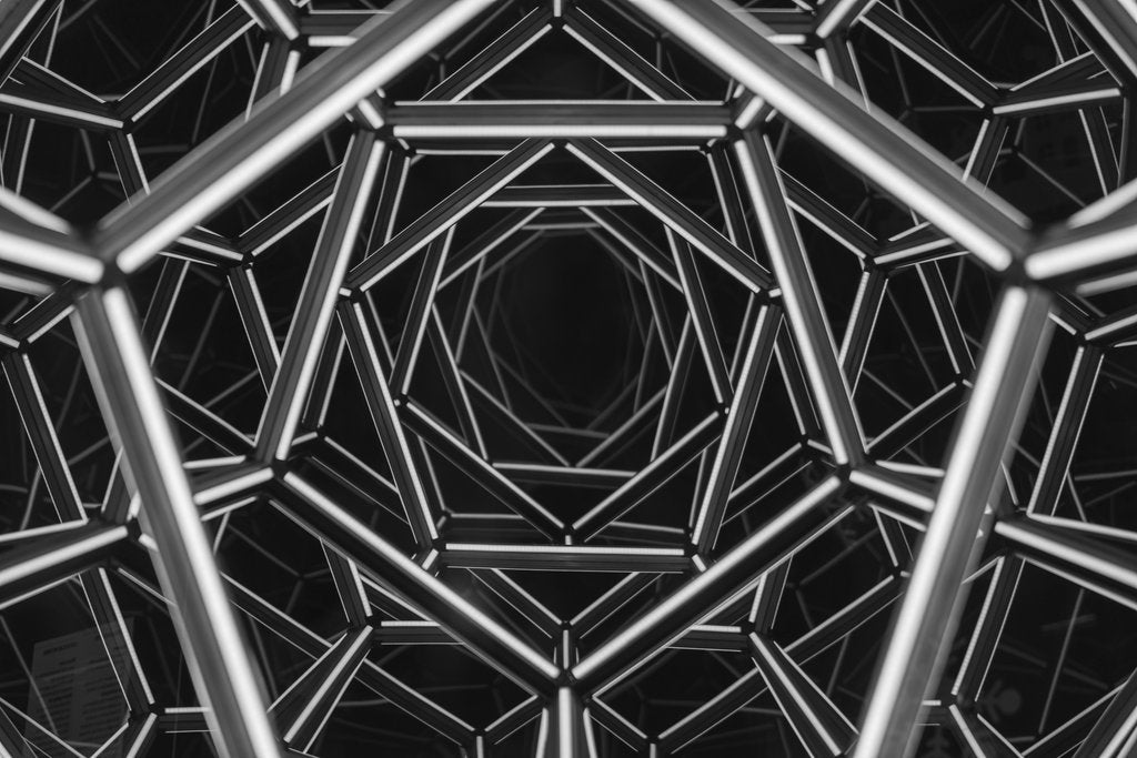 Vladimir Srajber - Black and white abstract photo focusing on intricate geometric metal structure with a tunnel-like appearance.