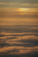 Sergio Zhukov - Breathtaking view of a sunset above the clouds, capturing the serene beauty of nature.