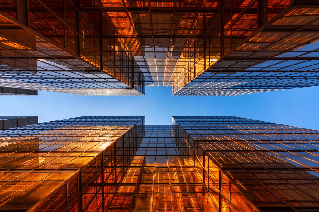 Stock Photos - Golden building with blue sky. Windows glass of modern office skyscrapers. facade design. Architecture exterior for cityscape background.