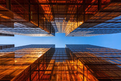 Stock Photos - Golden building with blue sky. Windows glass of modern office skyscrapers. facade design. Architecture exterior for cityscape background.
