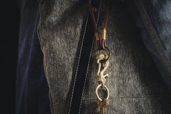 COPPERTIST WU - Elegant close-up of a golden keychain against textured fabric, perfect for accessory and fashion themes.