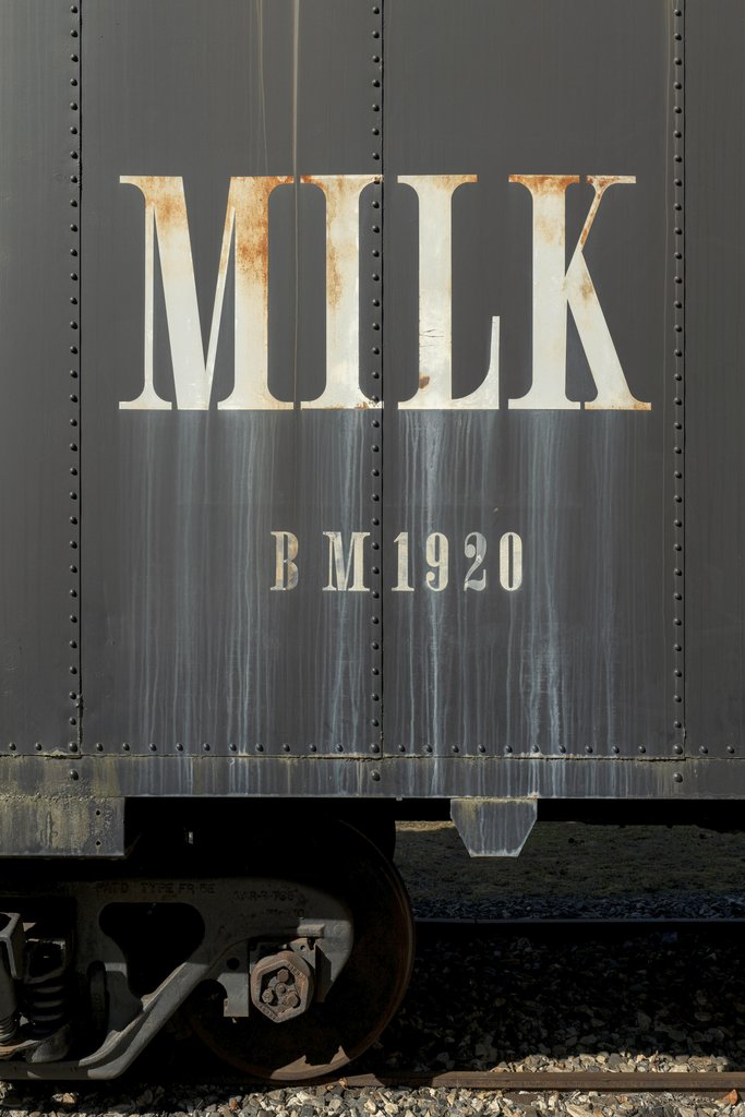 James Mirakian - Close-up of an antique train car featuring milk branding from 1920.