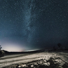 Евгений Шухман - A breathtaking view of a starry night sky over a desert landscape, showcasing the Milky Way.
