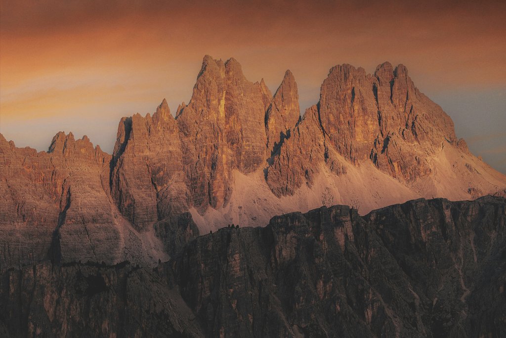 eberhard grossgasteiger - Majestic Dolomites mountain peaks illuminated by warm sunset hues, showcasing dramatic natural beauty.