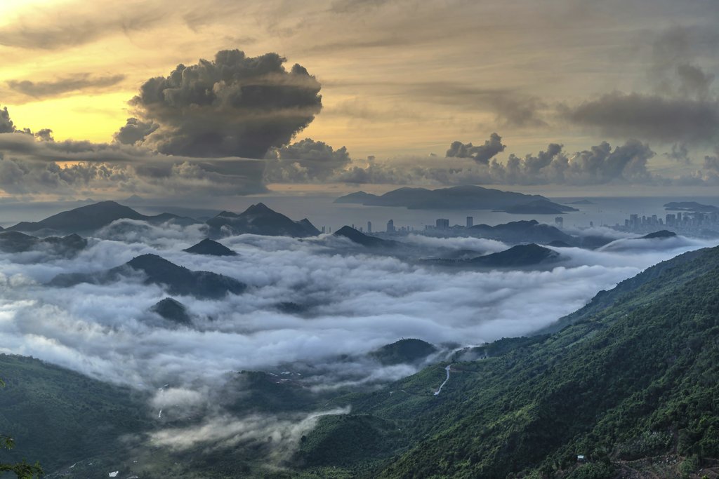 Quang Nguyen Vinh - A stunning vista of mountains covered in clouds during a vibrant sunset, showcasing nature's beauty.