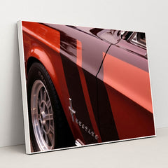 This artwork features a close-up of a classic red Ford Mustang with black and red racing stripes, in a white frame.