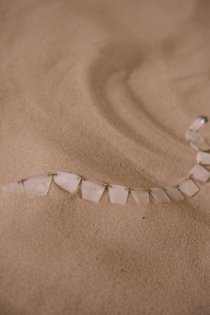 cottonbro studio - A delicate necklace displayed on smooth sand, highlighting texture and elegance.