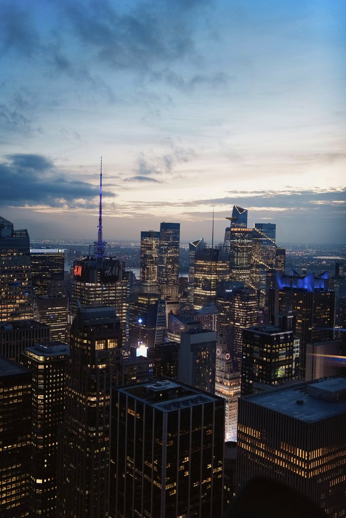 Shojol Islam - Stunning aerial view of New York City skyscrapers illuminated at dusk.