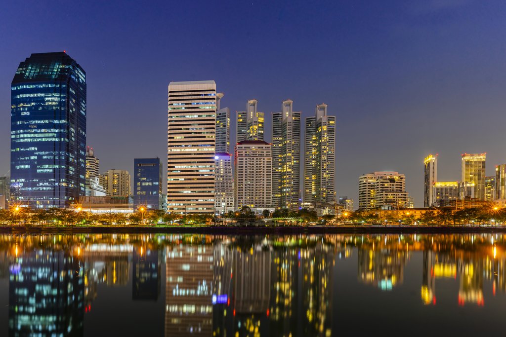 Stock Photos - Panorama building city in business area night scene with river reflection in Bangkok, Thailand.