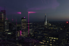 Olga Lioncat - Stunning view of the London skyline at night, featuring iconic skyscrapers and vibrant city lights.