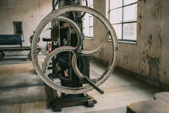 Sami TÜRK - Close-up of a vintage industrial machine in an abandoned factory setting.