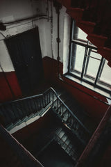 Viktor Mogilat - Dimly lit staircase in an old building, creating a dramatic and atmospheric scene.