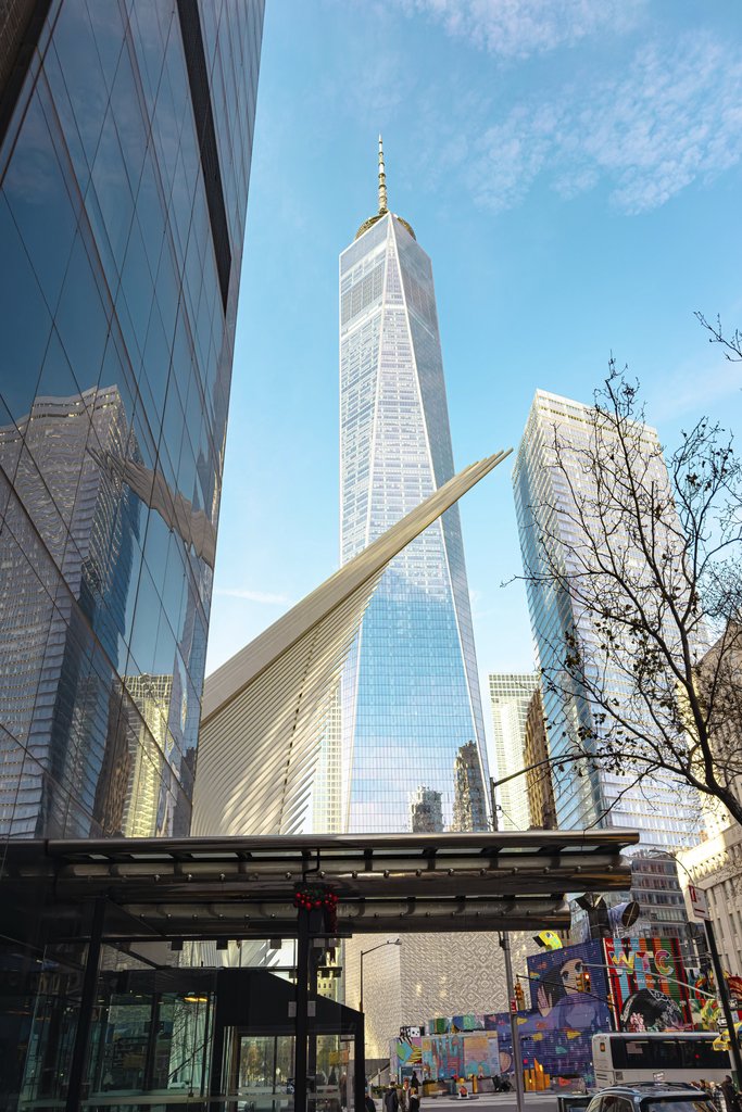 Supreme From Queens - View of One World Trade Center with surrounding architecture in NYC on a clear day.
