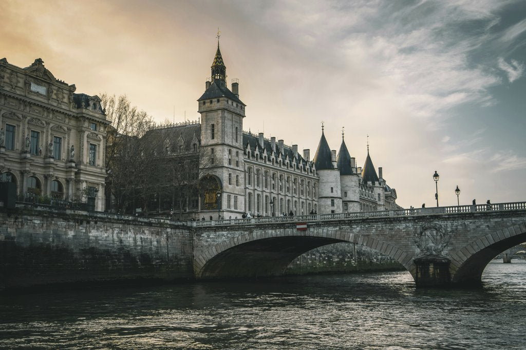 Hans D. - View of the historic Conciergerie and Pont au Change in Paris during a picturesque sunset over the Seine River.