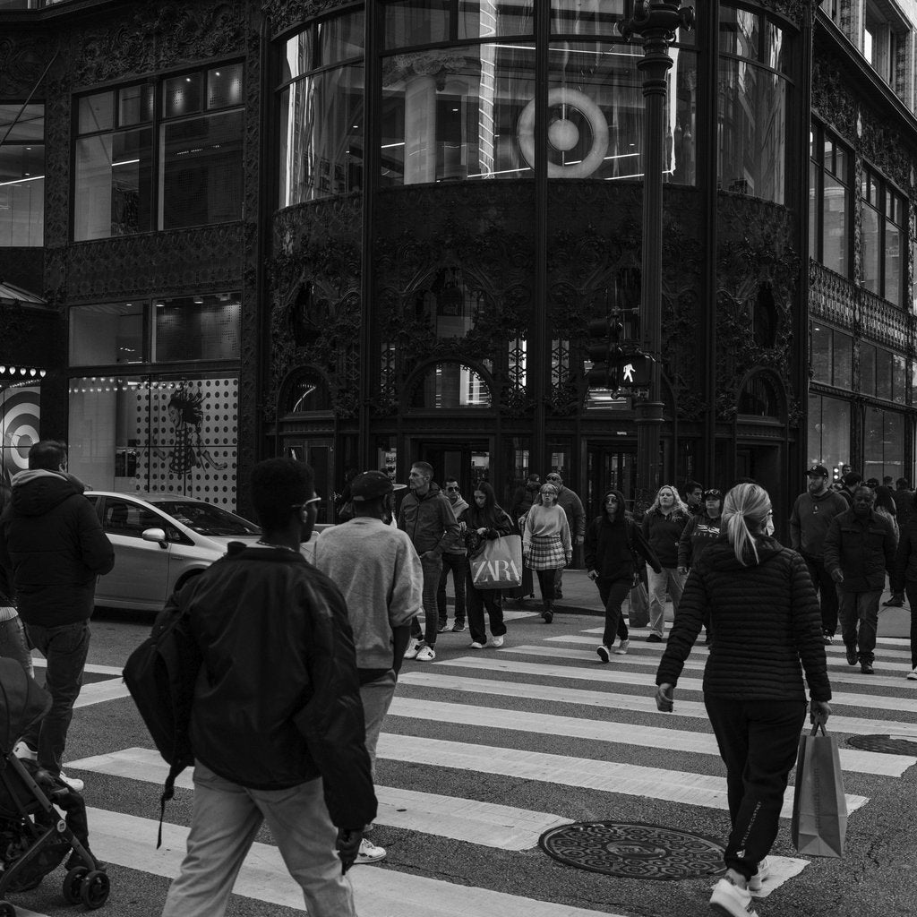 Qiang Lai - A bustling city street scene with people crossing at a crosswalk in an urban environment.
