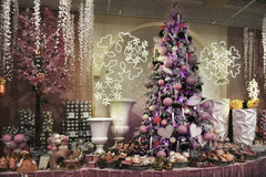 Serena Koi - A beautifully arranged pink-themed Christmas decoration setup featuring a tree and ornaments.