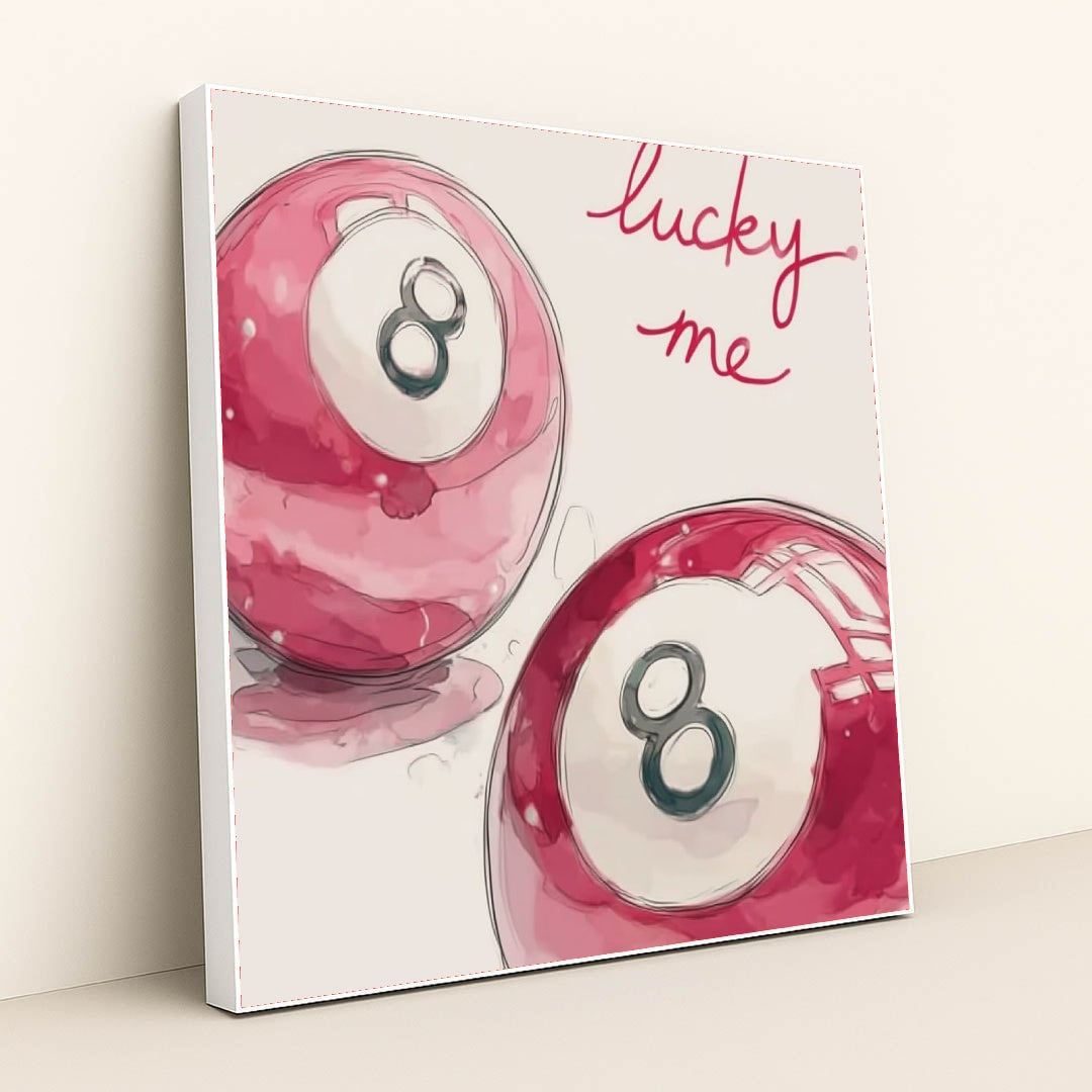 This artwork shows two pink magic eight balls with the words "lucky me" written in bright script above, in a white frame.