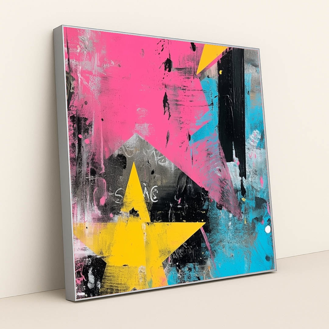 This artwork shows an abstract artwork with large yellow stars, pink and blue brushstrokes, and black and white textures, in a silver frame.