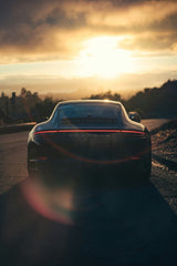 Black Porsche in Sunset Light, showcasing its sleek design against a stunning sunset backdrop, perfect for car wall art.