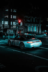 Porsche 911 in the Urban Night, a sleek car at a red light surrounded by neon city lights, perfect car wall art.