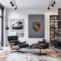 Porsche Crest in the Rain displayed as elegant car wall art above a modern lounge chair in a stylish interior.
