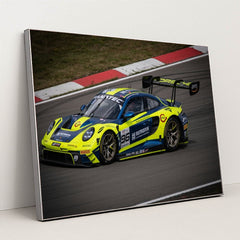 This photo shows a blue and yellow Porsche race car numbered 96 on a racetrack, in a silver frame.