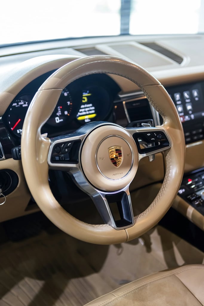 Porsche Tan Luxury Interior featuring a tan leather steering wheel with Porsche crest and modern digital display, car wall art.