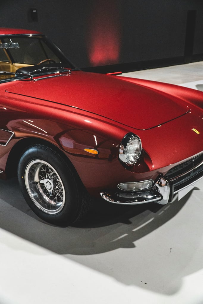 Ferrari 1960s Classic red car close-up showcasing wire-spoke wheels and chrome accents for car wall art.