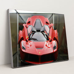 This photo shows a red Ferrari LaFerrari with scissor doors open, displayed indoors under soft lighting, in a silver frame.