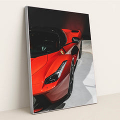 This photo shows a close-up of a red Ferrari LaFerrari highlighting its sleek curves and headlight, in a silver frame.