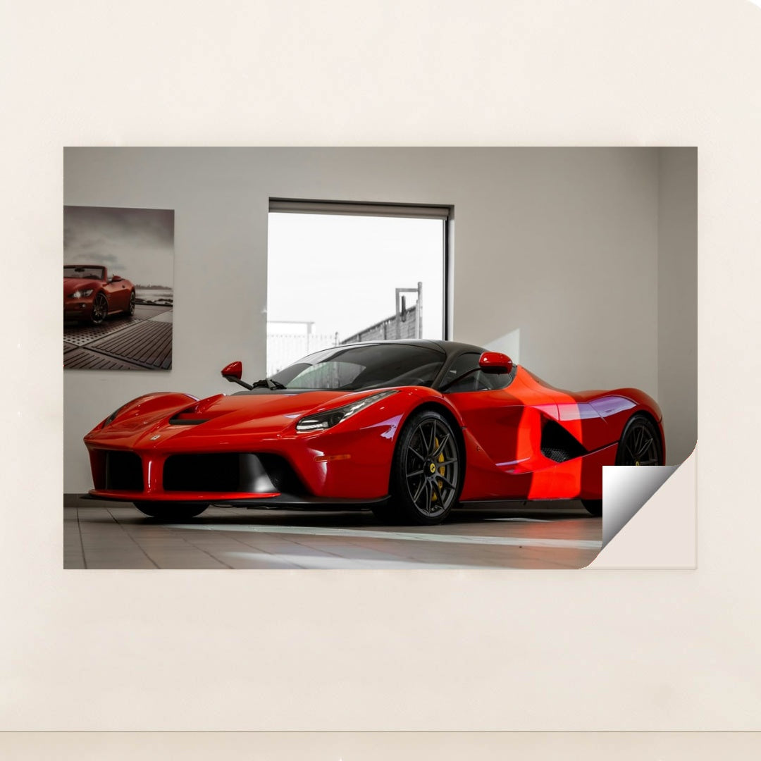 This photo shows a red Ferrari LaFerrari coupe displayed in a bright, modern showroom, unframed style.