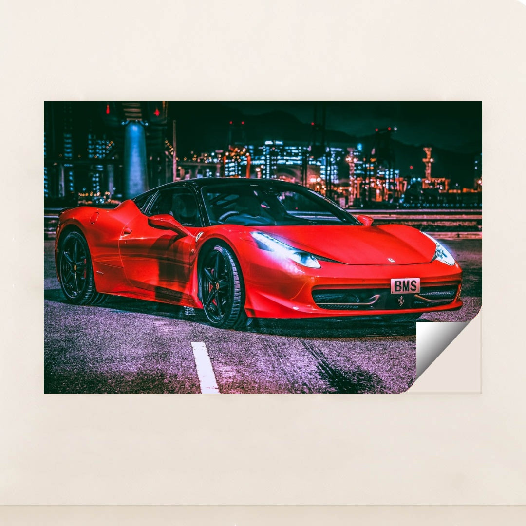 This photo shows a red Ferrari 458 Italia with black wheels parked under city lights at night, unframed style.