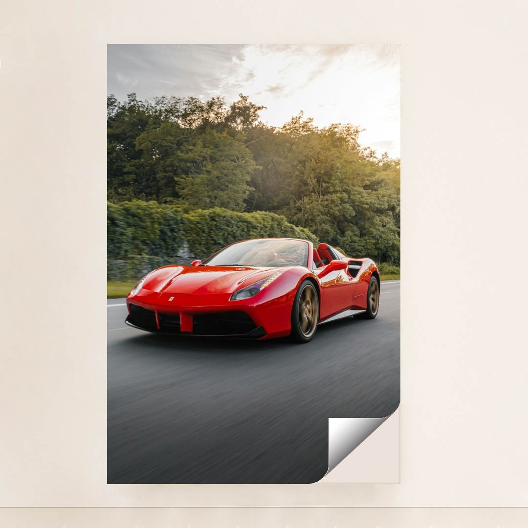 This photo shows a red Ferrari 488 Spider driving on a road with trees in the background, unframed style.