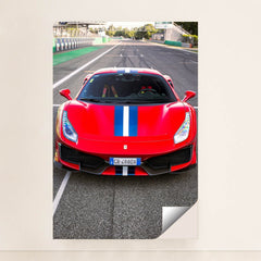 This photo shows the front view of a red Ferrari 488 Pista with a blue and white racing stripe parked on a racetrack, unframed style.