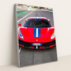 This photo shows the front view of a red Ferrari 488 Pista with a blue and white racing stripe parked on a racetrack, in a silver frame.
