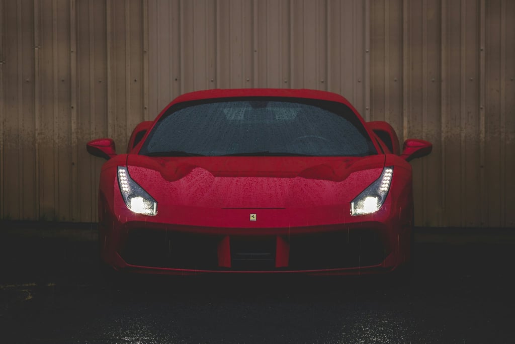 Rain-Soaked Ferrari 488 GTB captured in striking red with water droplets on its sleek body, a perfect car wall art.