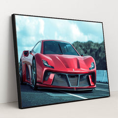This photo shows a red Ferrari sports car with aggressive styling and carbon fiber accents on a racetrack, in a black frame.