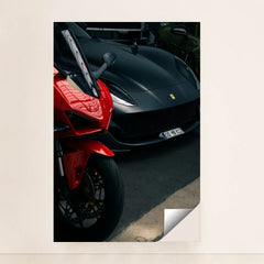 This photo shows a red sport motorcycle next to a matte black Ferrari sports car in a parking area, minimalist unframed style.