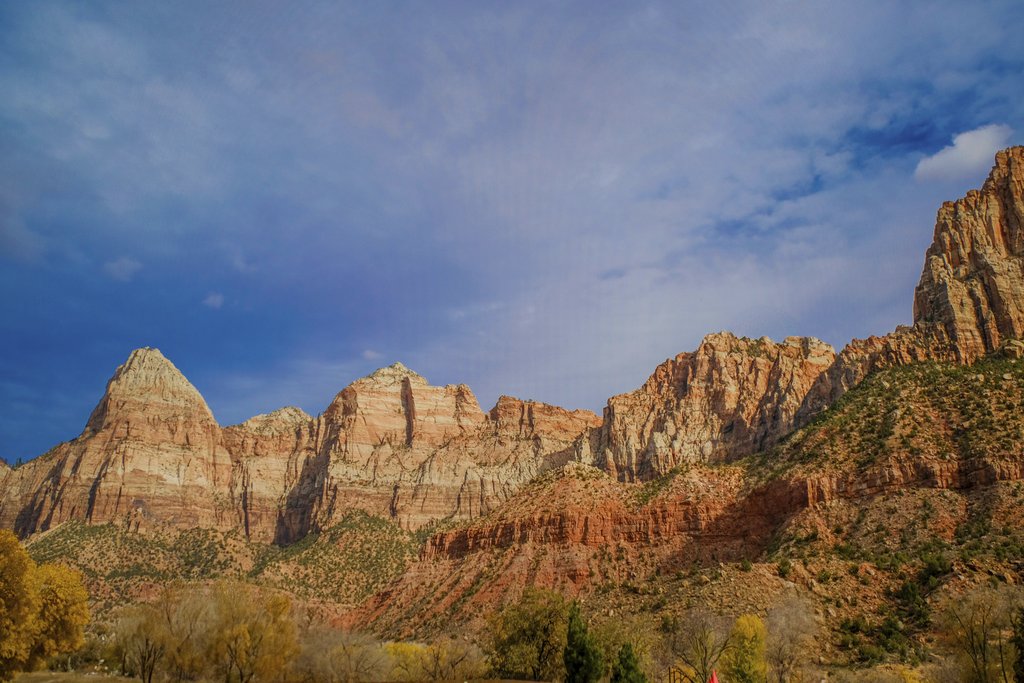 Arian Fernandez - Vibrant red rock cliffs under a blue sky in Zion National Park during autumn.
