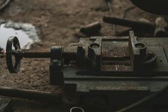 Tahamie Farooqui - Close-up of rusty industrial tools in a workshop setting, emphasizing craftsmanship.