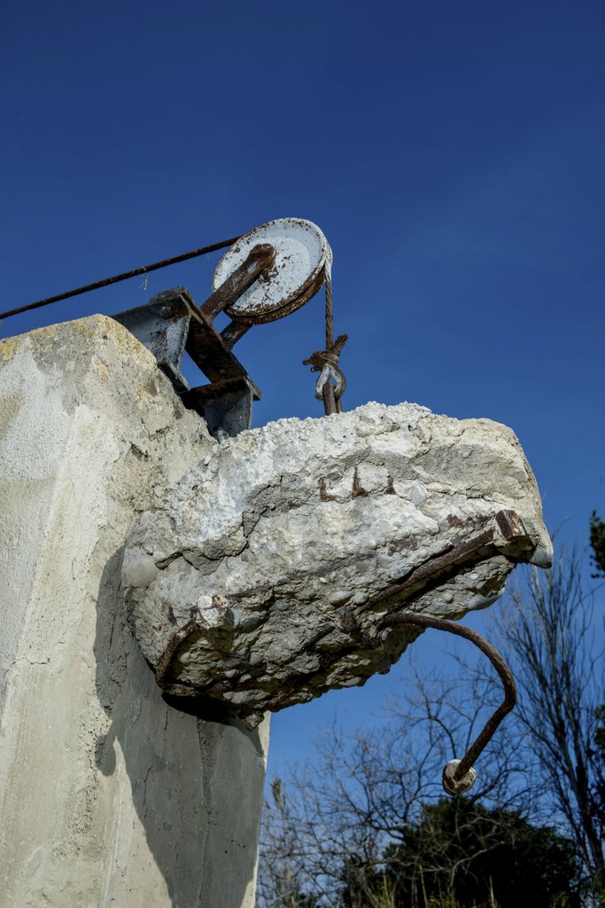 Victor Moragriega - Abandoned Concrete Structure With Rusty Pulley
