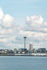 Jared Lung - A captivating view of Seattle's skyline featuring the iconic Space Needle under a bright cloudy sky.