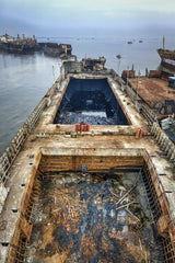 Tom Fisk - From above of aged rusty damaged ship floating on calm water of ocean in cloudy day