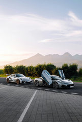 Maserati MC20 Meets Porsche GT3 - Stunning car wall art featuring two supercars against a scenic mountain backdrop.